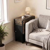 [Rustic] Small folding dining table closed beside a sofa featuring black cabinet with lamp, mug & books on wood-effect top.