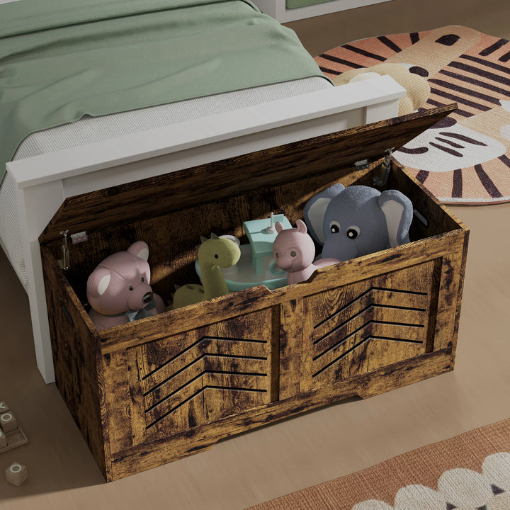 [Rustic] Wooden toy chest with stuffed animals inside, placed on a bed with green bedding.