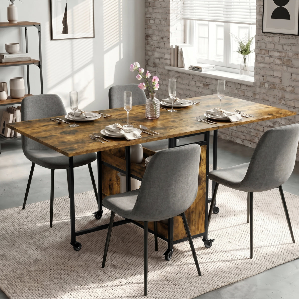 [Rustic] Stovra dining scene with warm rustic wood table surface, black frame, shelf storage, and caster wheels.