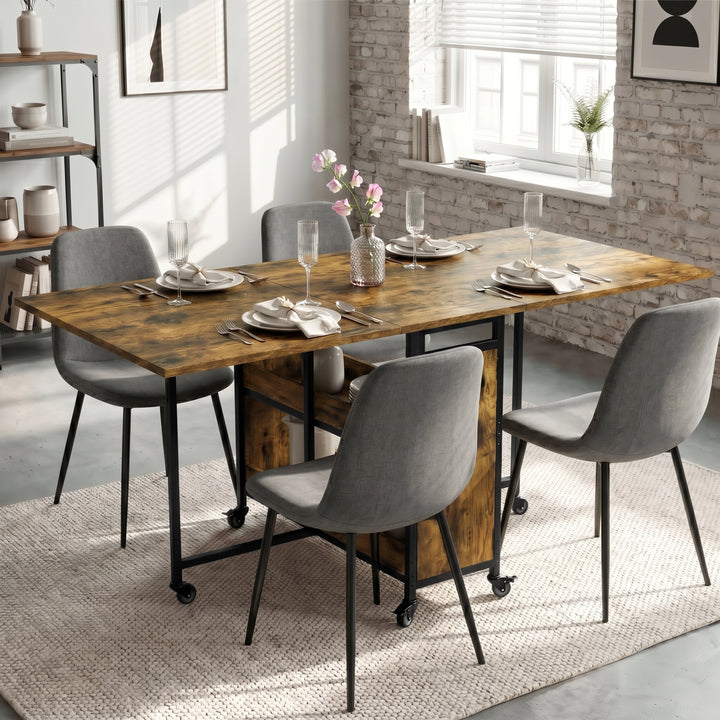 [Rustic] Stovra dining scene with warm rustic wood table surface, black frame, shelf storage, and caster wheels.