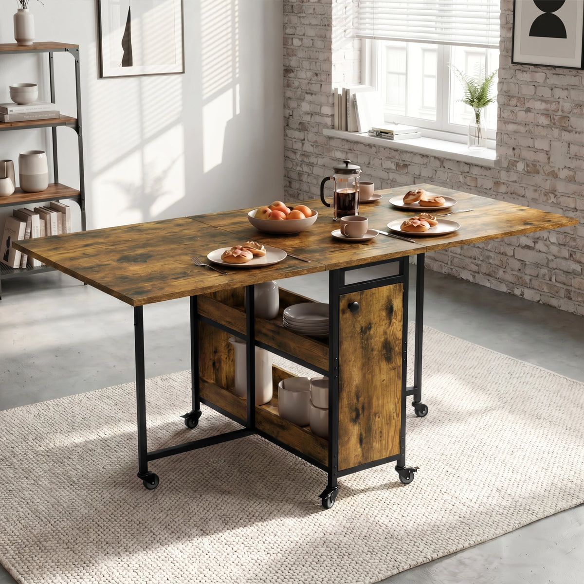 [Rustic] Kitchen & Dining Furniture Sets open drop leaf dining table with plates, cups, fruit, and centre storage.