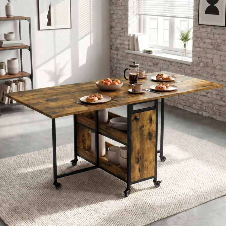 [Rustic] Kitchen & Dining Furniture Sets open drop leaf dining table with plates, cups, fruit, and centre storage.