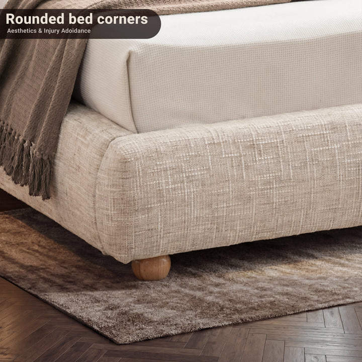 [Double | Beige] Close-up of bed frame corner showing rounded padded base with wooden ball foot on textured rug