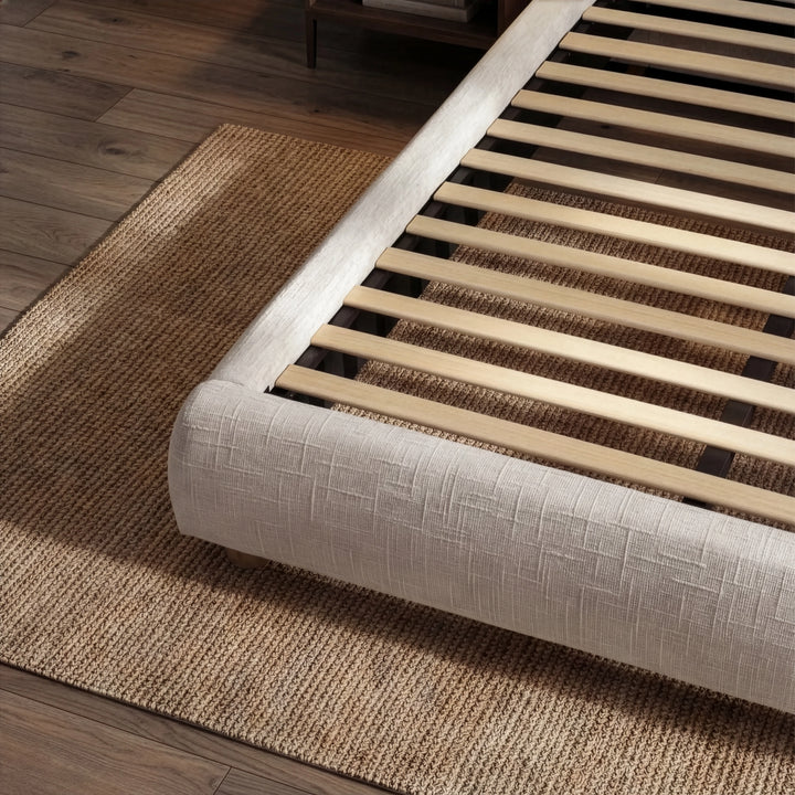 [Double | Camel] Bed frame base detail with wooden slats and woven fabric corner on herringbone floor