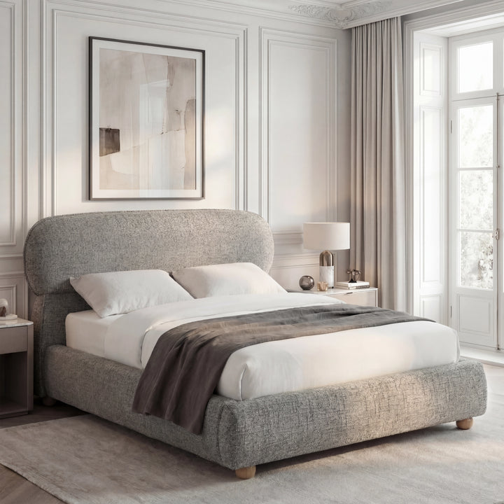 [Double | Grey] Woven fabric bed from the side with rounded headboard and grey throw beside window with sheer curtains
