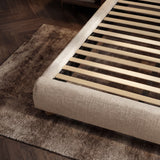 [King | Beige] Open slat support structure inside fabric bed frame with textured rug below