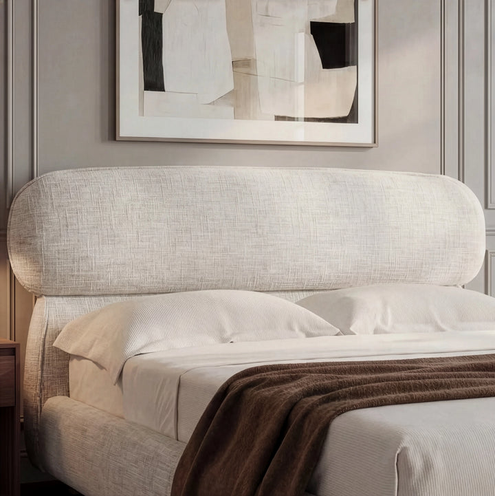 [King | Camel] Close-up of pill-shaped headboard showing woven linen-like fabric texture with rounded edges