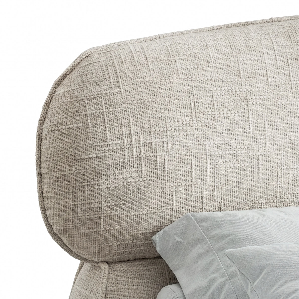 [King | Camel] Close view of headboard curved upper edge showing soft padded profile and woven fabric texture
