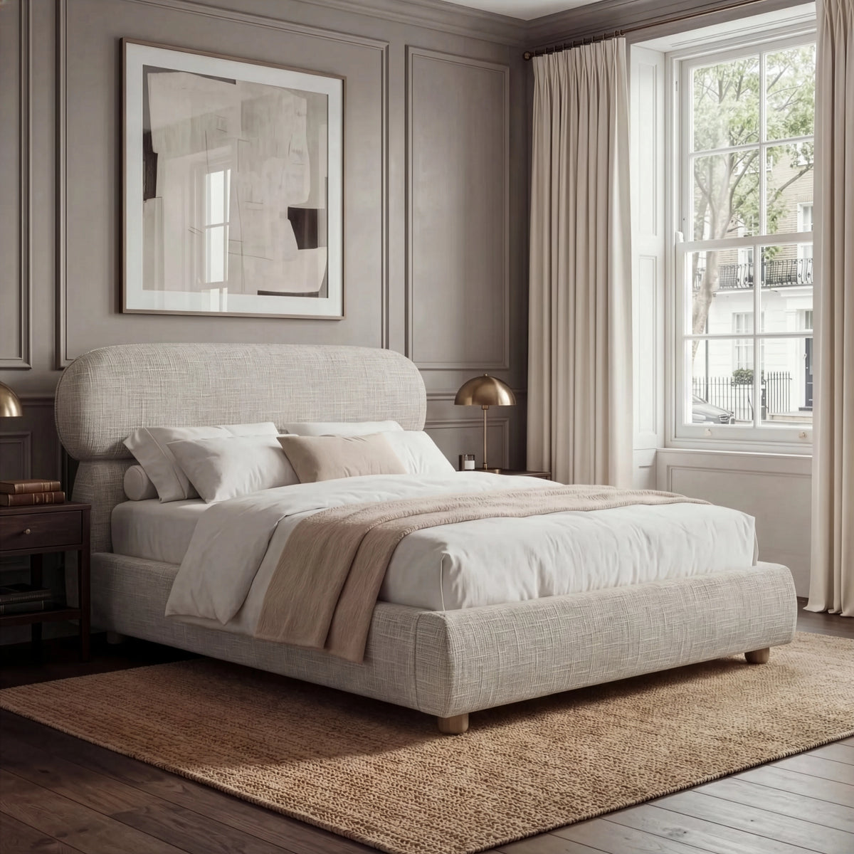 [King | Camel] Fabric bed with luxury rounded headboard beside nightstand with table lamp and natural daylight