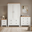 [White] Shaker white 2 door wardrobe, 2 over 2 drawer chest and 2 drawer bedside grouped on shaggy rug with oak tops