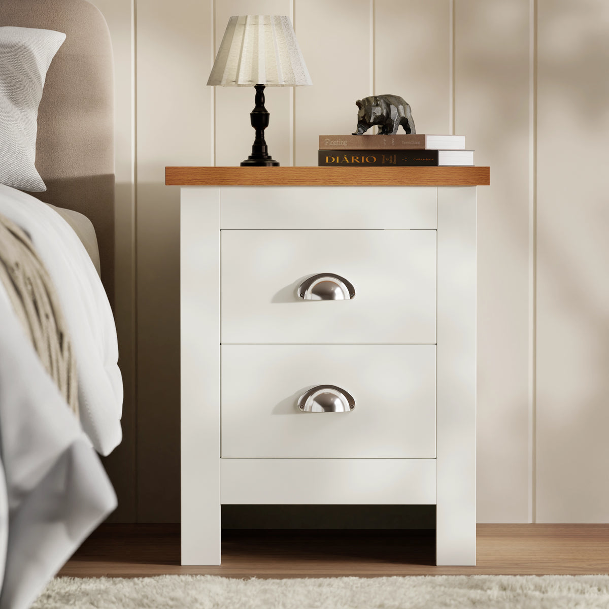 [White] Bedside in white finish with oak top and 2 closed drawers, panelled wall behind