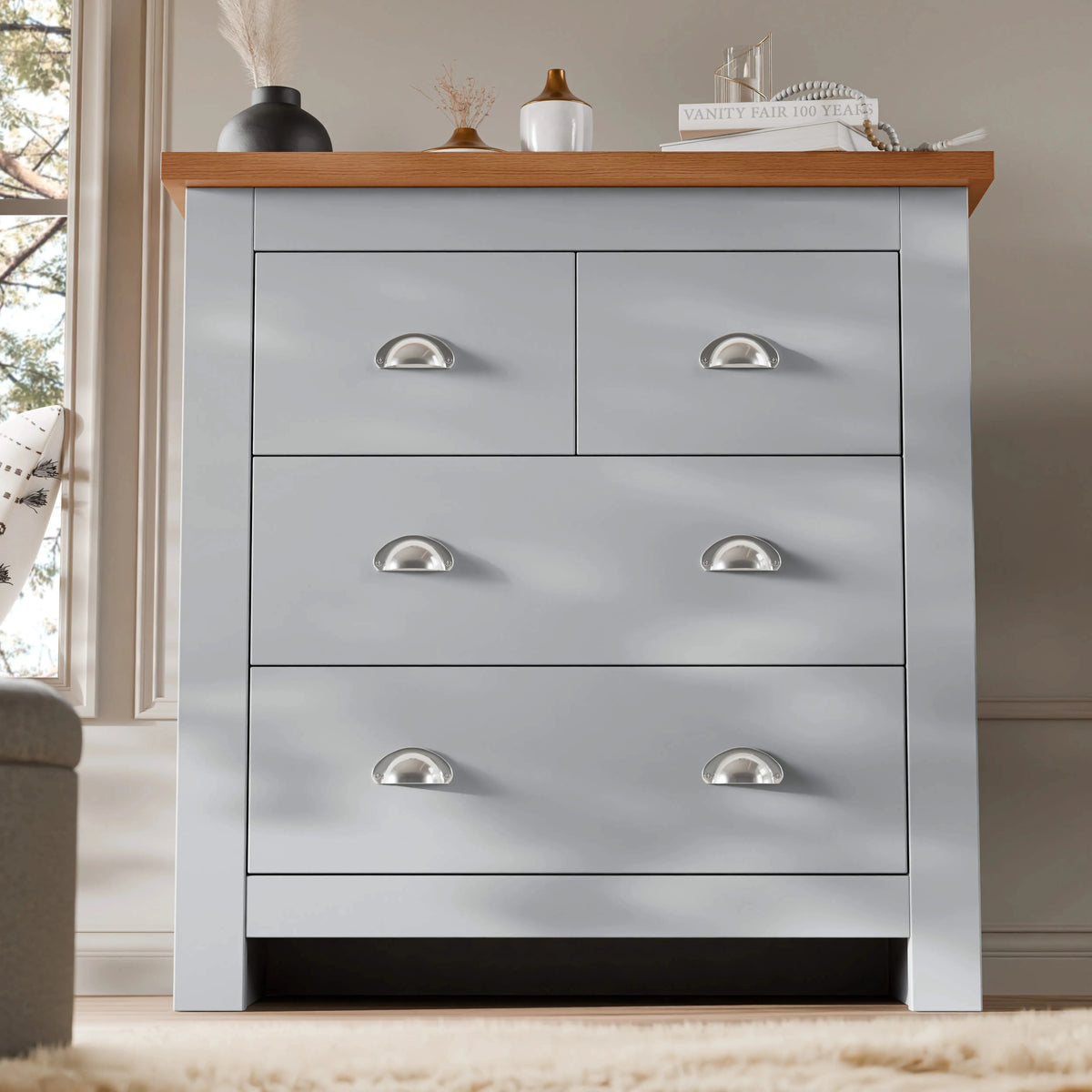[Grey] Grey four drawer chest with vase and books matching Shaker bedroom furniture set on rug