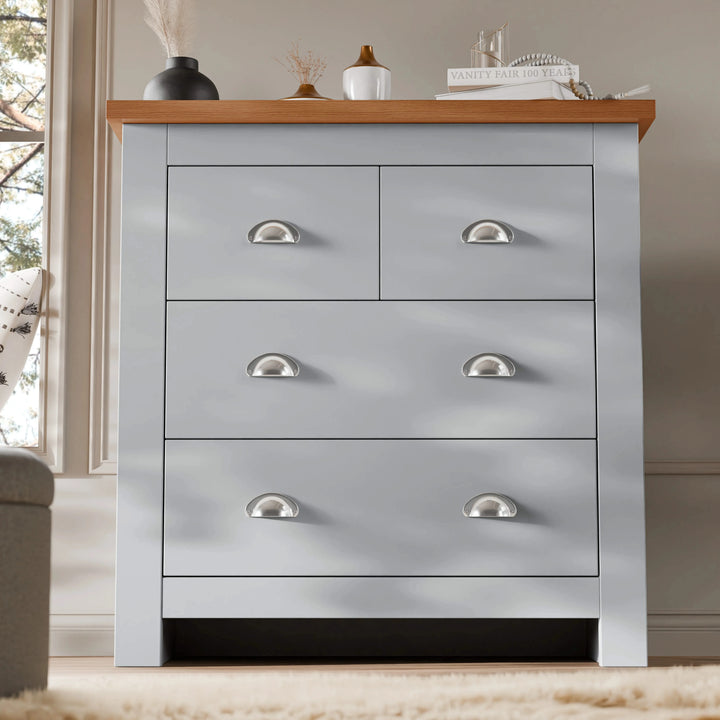 [Grey] Grey four drawer chest with vase and books matching Shaker bedroom furniture set on rug