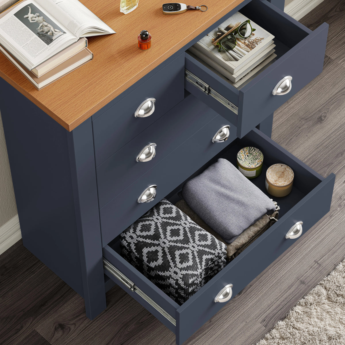 [Navy] Interior of 5 drawer chest showing metal runners, books and folded blanket inside