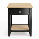 [Black] Front view showing the bedside table with centered drawer, open lower shelf and oak-effect top