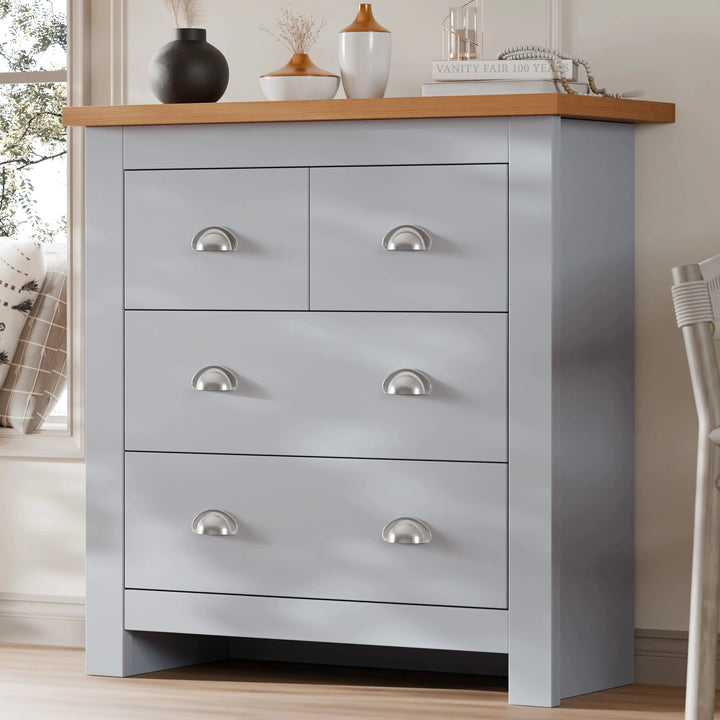 [Grey] Shaker chest of drawers in grey angled beside window, oak top styled with ornaments, cup handle pulls
