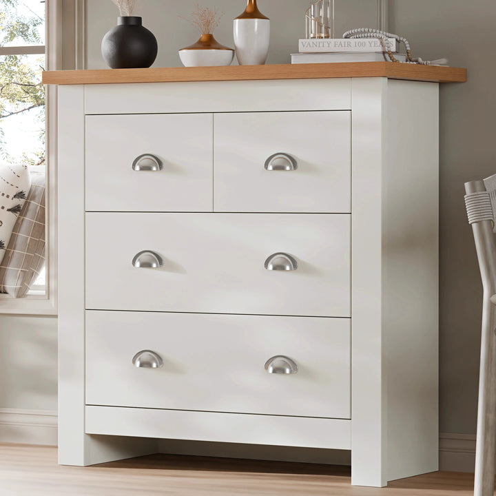 [White] Shaker chest of drawers angled by bedroom window, oak top with vases, silver cup handles, white frame