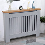 [Medium | Grey] Medium grey radiator cover with oak top and vertical slats, styled with toys and clock, perfect for children's rooms or living areas.