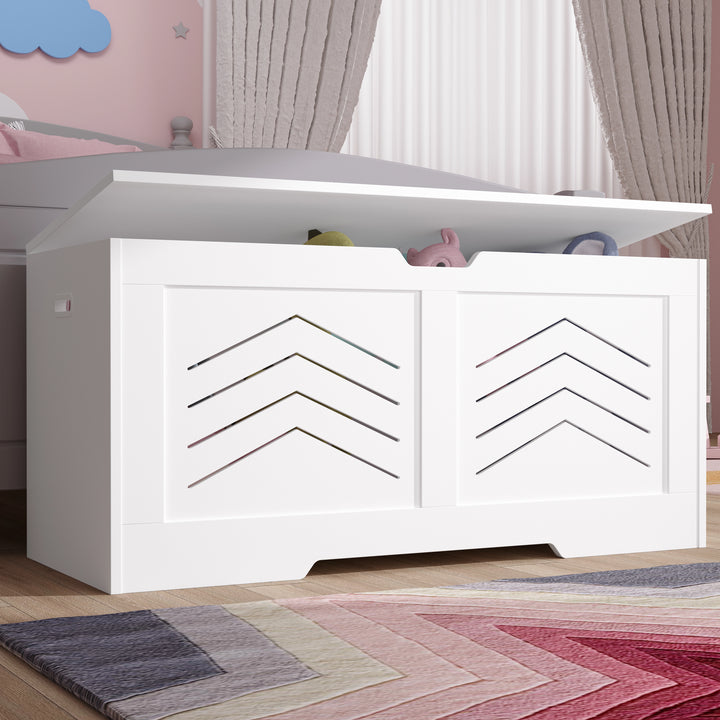 [White] Shaker toy box in white with chevron cutout panels and hinged lid in a kids bedroom by a rug