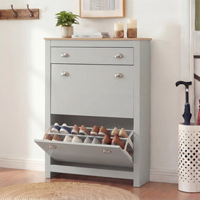 [Grey] Slim grey shoe cabinet front view, bottom compartment open beside white perforated umbrella stand