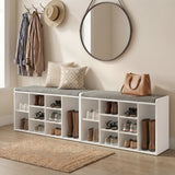 [White] Pair of shoe storage benches lining hallway wall with cushions, boots and shoes filling cubbies
