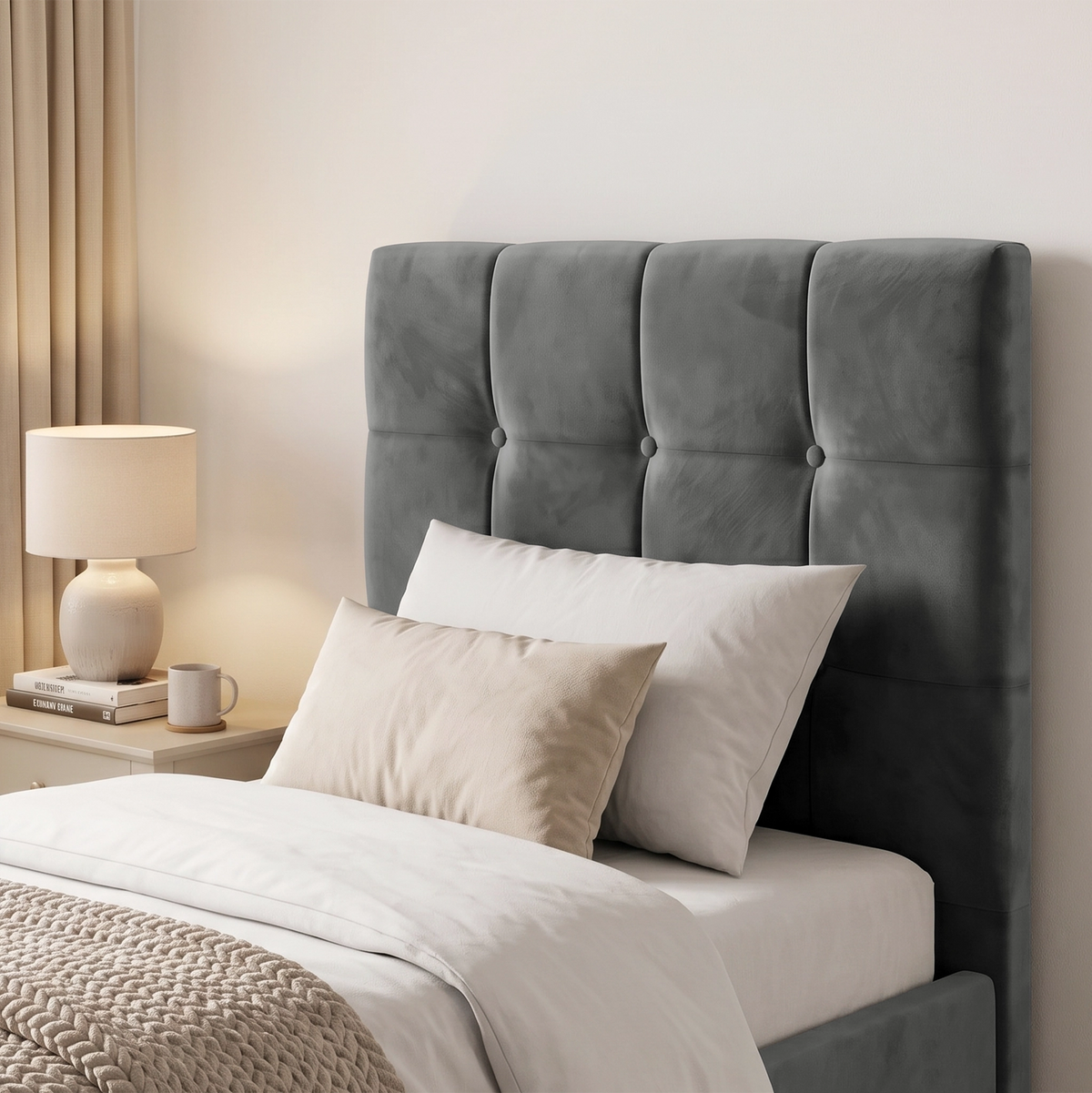 [Single | Dark Grey] Close-up of square panel headboard with button detail, white pillows, bedside lamp, books, and mug