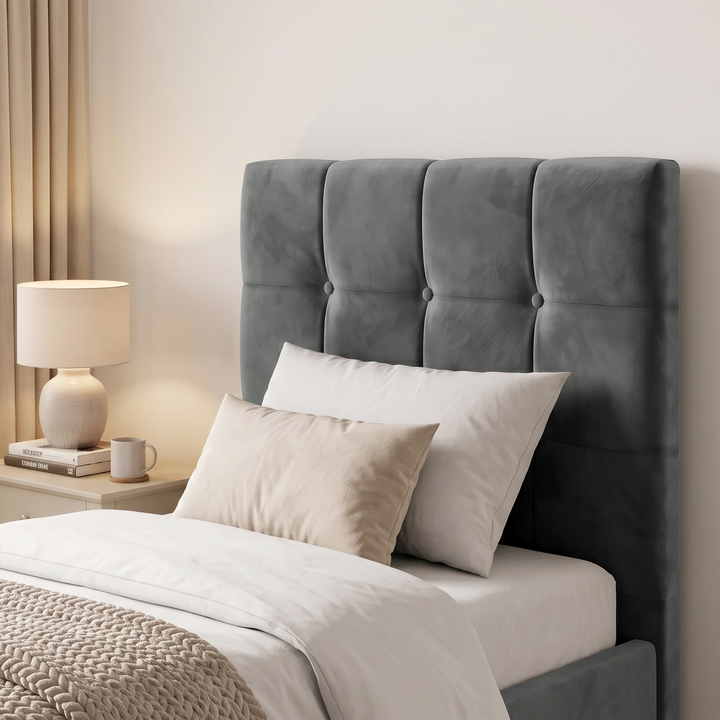 [Single | Dark Grey] Close-up of square panel headboard with button detail, white pillows, bedside lamp, books, and mug