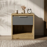 [Oak+Grey]  Wooden nightstand with a gray drawer and decorative items on top against a neutral wall.