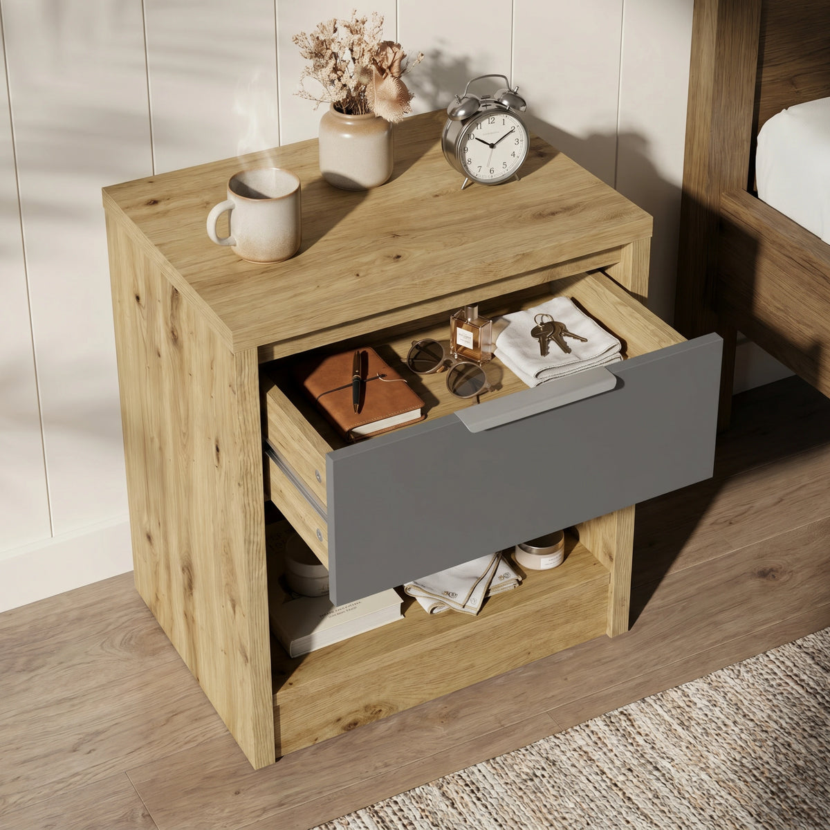 [Oak+Grey] Top-down detail of Skova bedside table with grey drawer fully out, oak surround and reading glasses on top