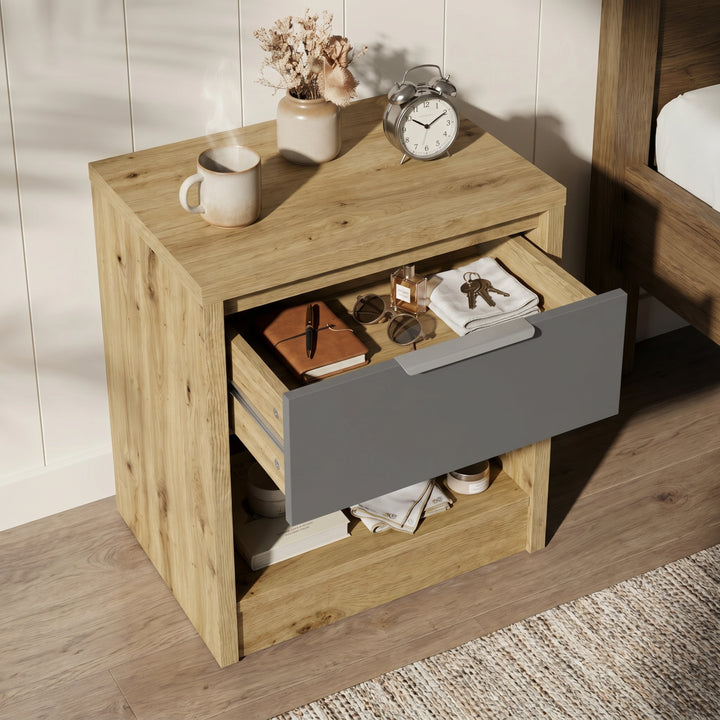 [Oak+Grey] Top-down detail of Skova bedside table with grey drawer fully out, oak surround and reading glasses on top