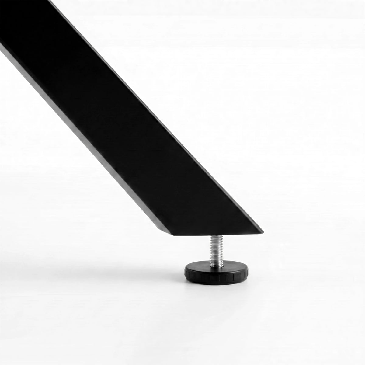 [Black] Skyra dining table set adjustable foot pad at the end of a black angled table leg