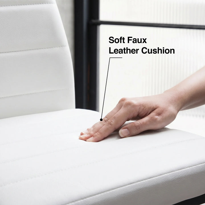 [White] Skyra dining table set chair cushion detail showing hand pressure on the faux leather surface
