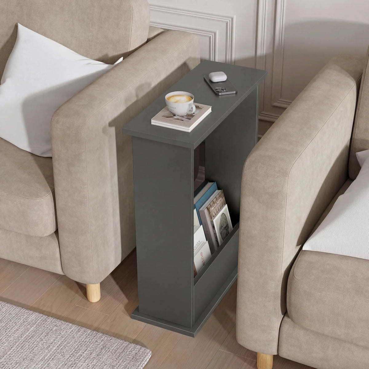 [Slate Grey] Narrow Side Table tucked snugly between two beige sofas with coffee cup, phone, earbuds, and books stored below