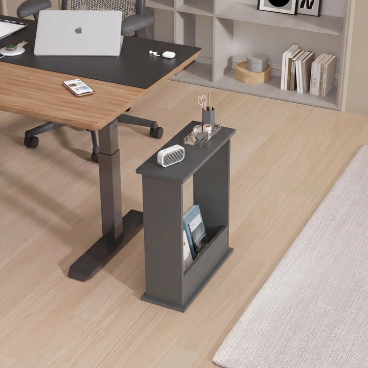 [Slate Grey] Narrow Side Table beside a wooden home office desk with stationery tray, small fan, magazines below, and laptop on adjacent desk
