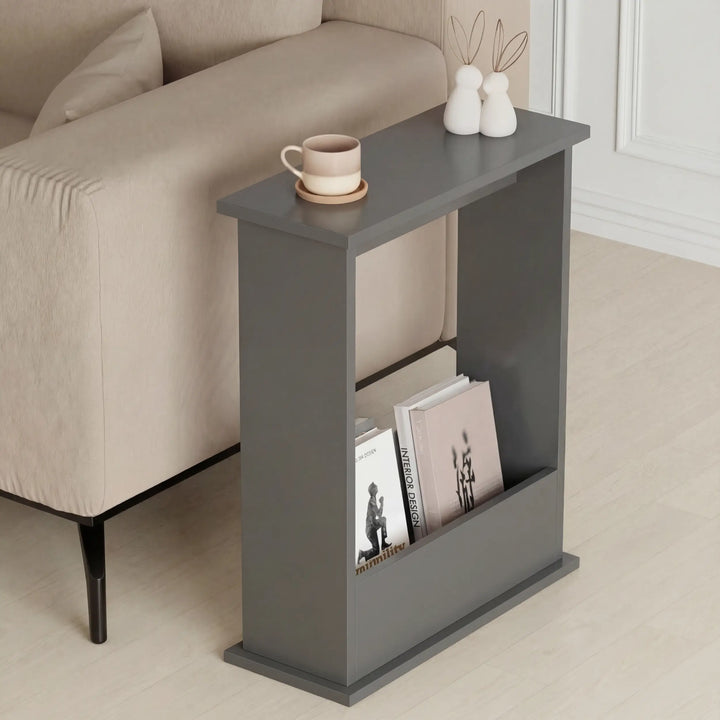 [Slate Grey] Narrow Side Table styled next to a beige sofa with coffee cup, bunny figurines, and design magazines tucked into the storage compartment