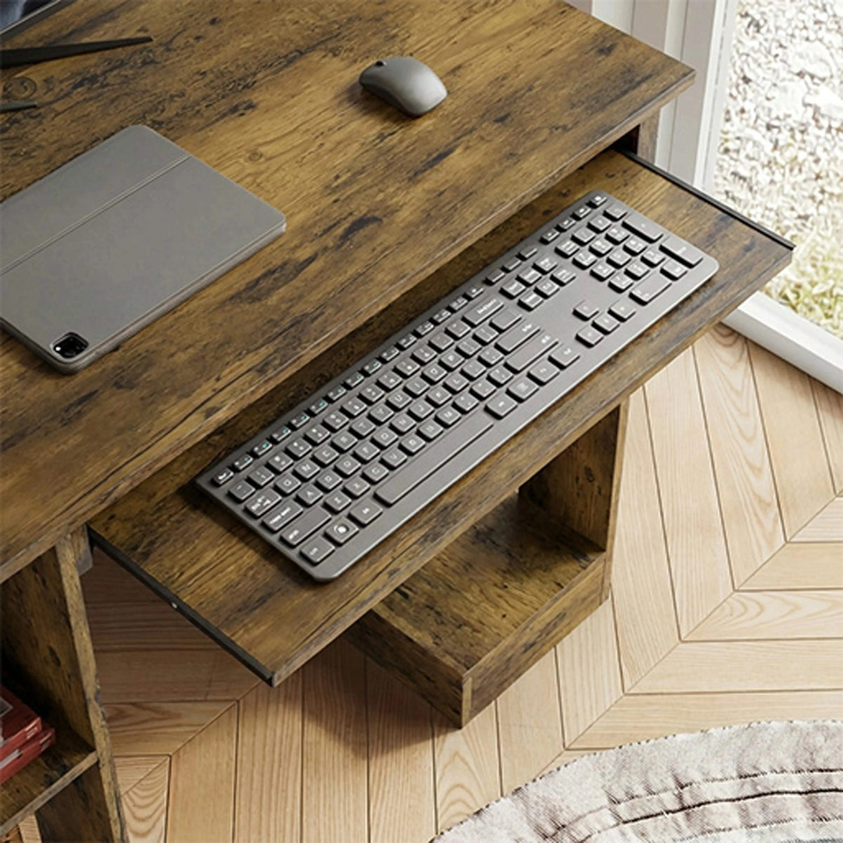 [Rustic] Keyboard tray view of rustic computer desk, tablet propped at left, full-size keyboard on the tray