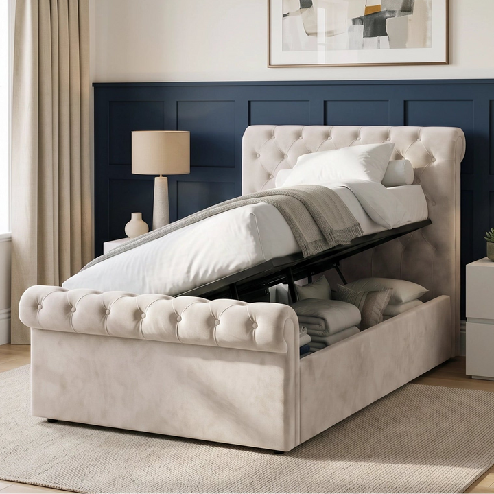 [Small Double | Beige] Side-lift storage view with raised mattress base, black frame, folded bedding, pillows, and twin lamps