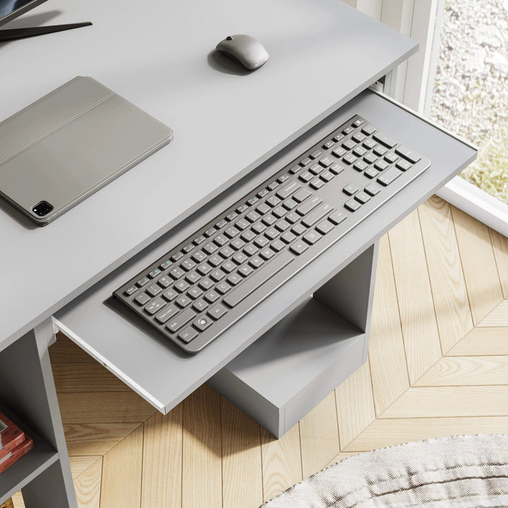 [Grey] Close-up of pull-out keyboard tray on small computer desk in grey with grey keyboard and mouse on top