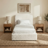 [White | Single] Sofna boucle ottoman bed front elevation, white boucle single frame centred between matching lamps