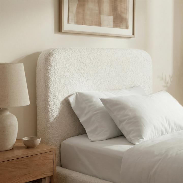 [White | Single] White boucle ottoman bed headboard texture close-up, looped curled fibres on rounded puffed panel