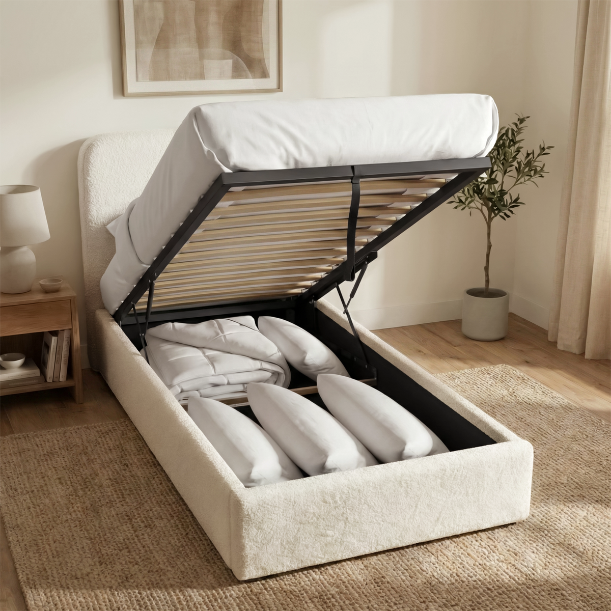 [White | Single] Boucle ottoman bed with gas lift raised from foot end, wooden slats and central iron support bar visible