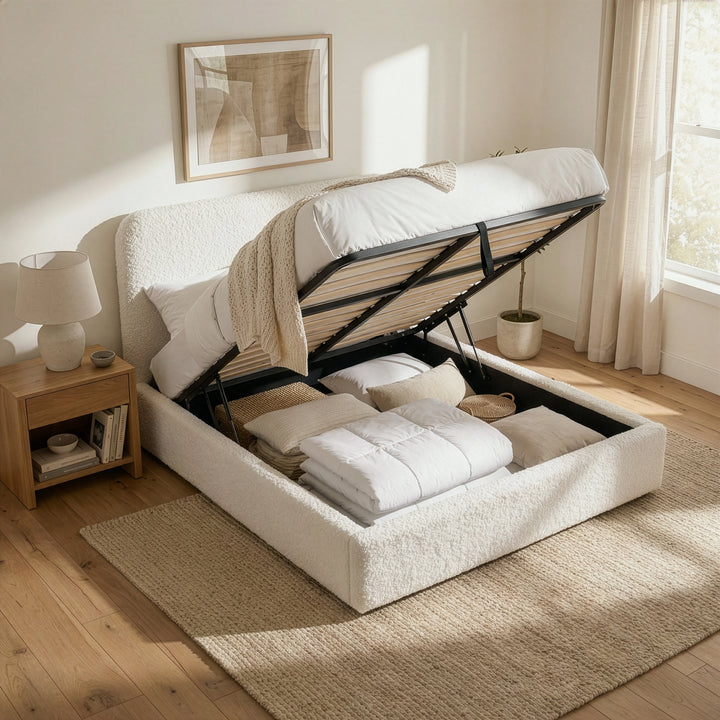 [White | Small Double] Lift-up base raised on small double boucle bed showing deep under-bed storage beside oak nightstand