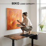 [160cm x 70cm] 80KG load demo on 160cm rustic standing desk; a person crouches on top while painting on the wall