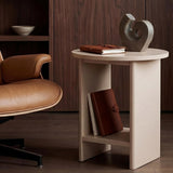 [Taupe] Small Round Side Table with Shelf Living Room beside tan leather armchair with sculptural object and journal on top and book stored on lower shelf