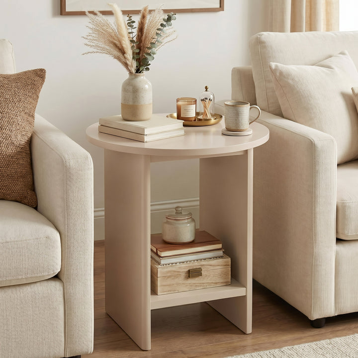 [Taupe] Small Round Side Table with Shelf Living Room positioned between two cream sofas with pampas vase on top and stacked books and wooden box on lower shelf