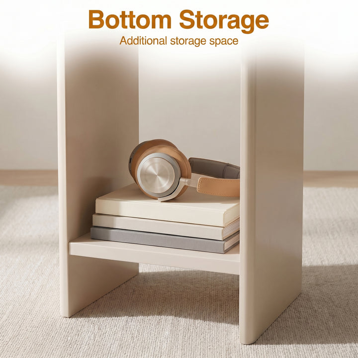 [Taupe] Small Round Side Table with Shelf Living Room close-up of lower storage shelf between panel legs holding stacked books and headphones on beige rug