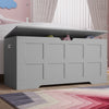 [Grey] Grey toy storage box with children's toys inside, placed on a wooden floor in a room with pink walls and a colorful rug.