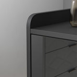 [Black] close-up of black TV unit upper corner with rounded recessed tray rim and gloss diamond pattern door