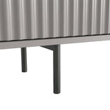 [Grey] Close-up of two slim dark legs at base of grey Flutrina 180cm TV unit on light tile floor.