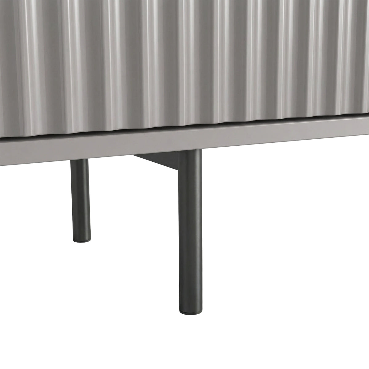 [Grey] Close-up of two slim dark legs at base of grey Flutrina 180cm TV unit on light tile floor.